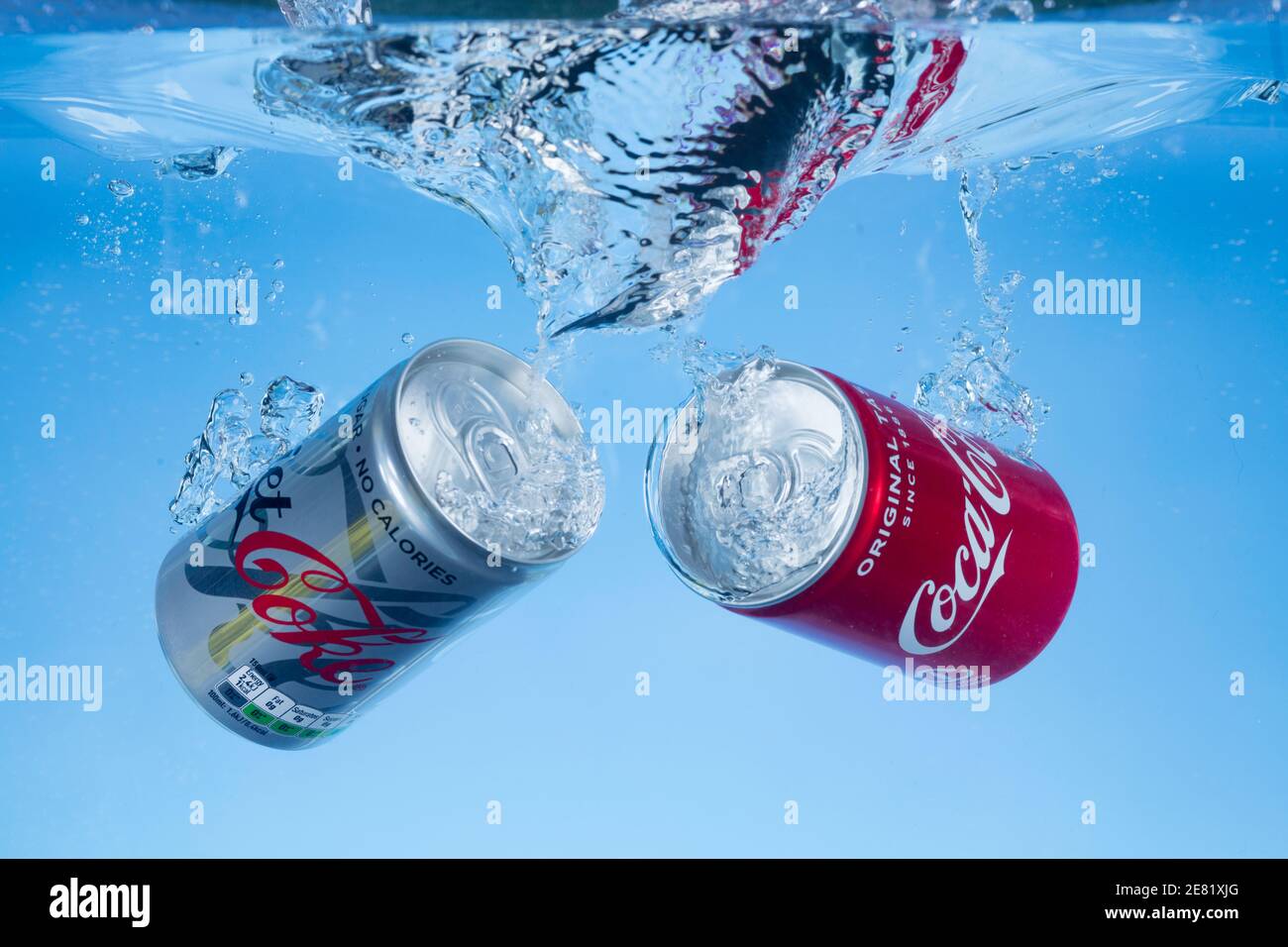 Freeze motion photo of mini cans of diet coke and coca cola dropped