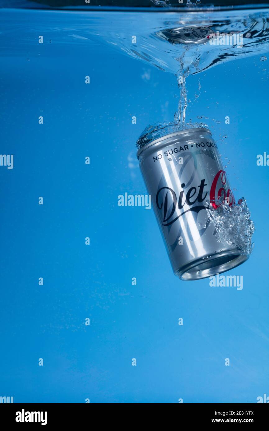 Freeze motion photo of a mini Diet Coke can dropped into water. Stock Photo