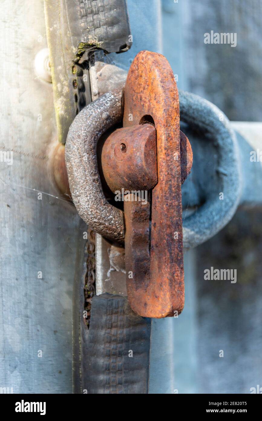 a close up view of a rusted slide lock on the side of a house box Stock ...