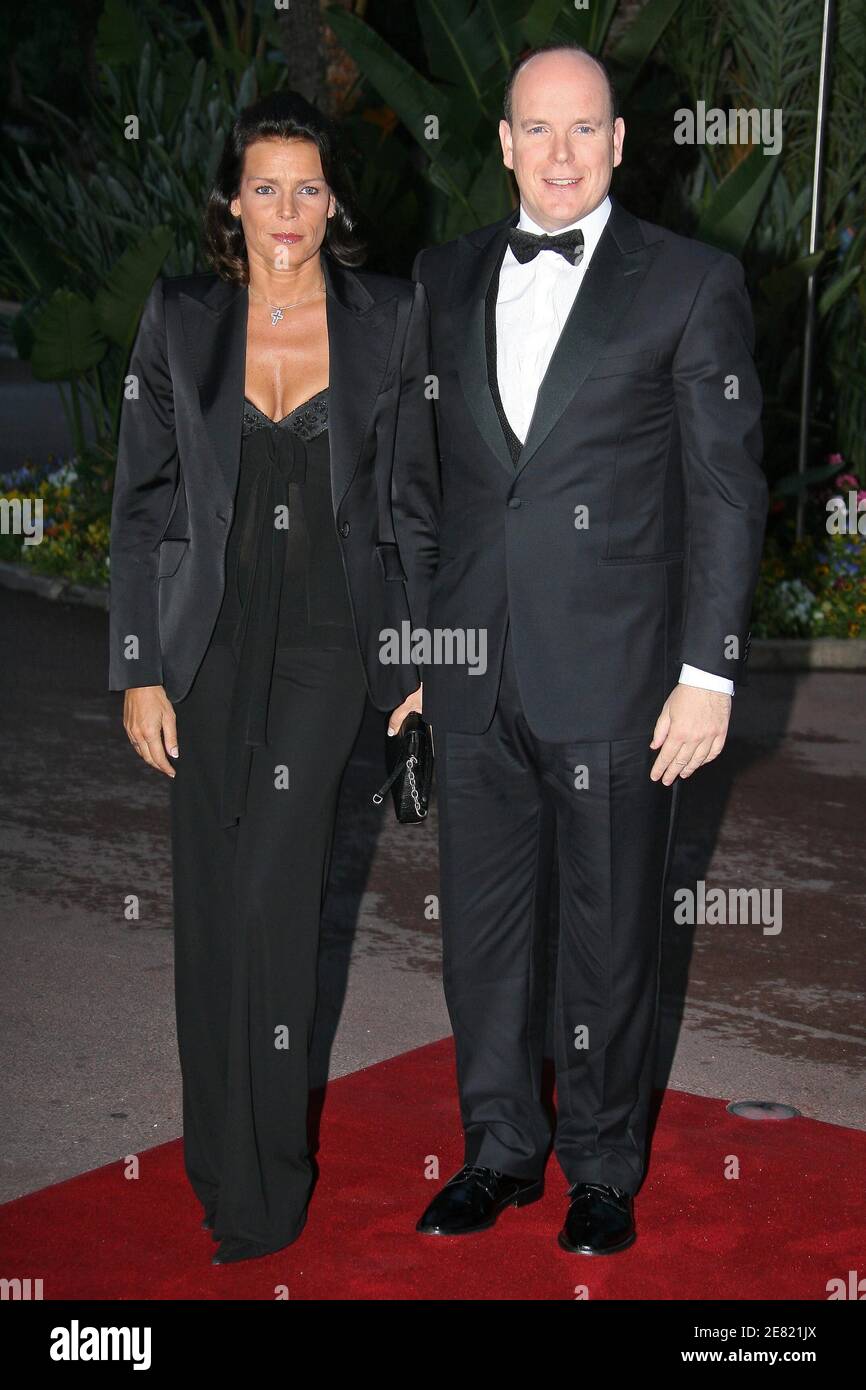 Prince Albert II of Monaco and his sister Princess Stephanie of Monaco pose  for picture as they arrive at the 'Tenue de soiree' television gala held at  the sporting hall in Monte-Carlo,