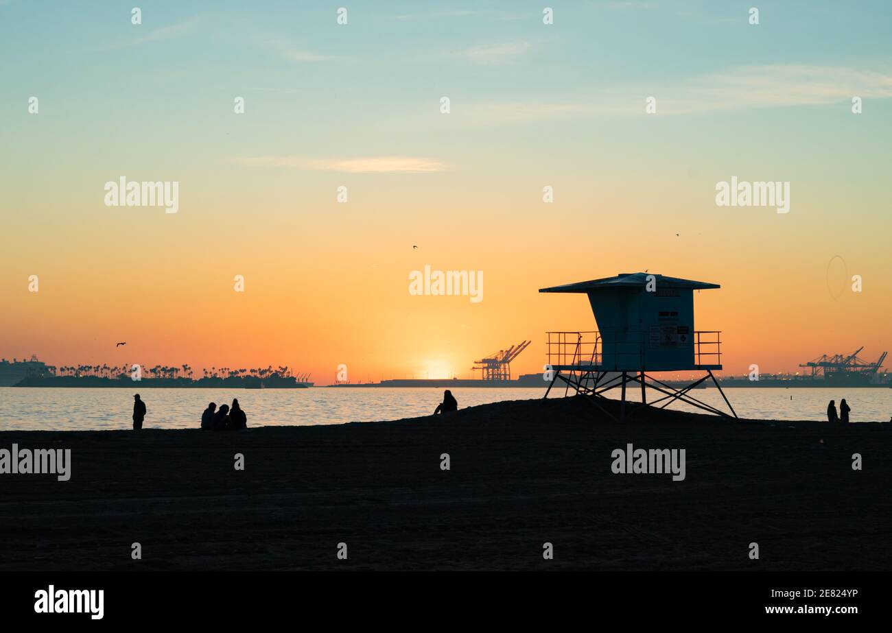 Sunset view of lifeguard and visitors near Long Beach Stock Photo