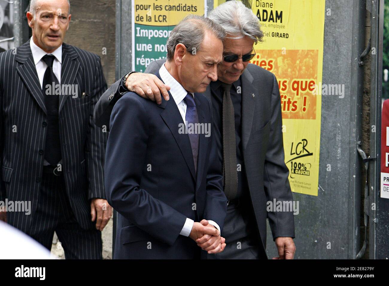 Paris Mayor Bertrand Delanoe and French actor Alain Delon (R) arrive at the  funeral mass for French actor Jean-Claude Brialy held at 'Saint-Louis en  l'Ile' church in Paris, France on June 4,