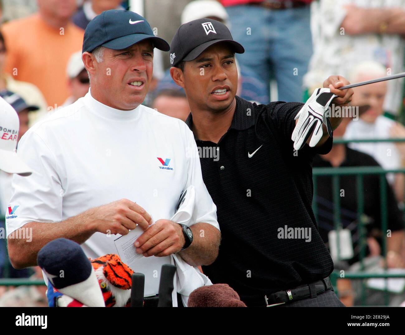 Tiger Woods (R) chats with his caddy Steve Williams before teeing off on the first hole during the second round of the Arnold Palmer Invitational golf tournament at the Bay Hill Club in Orlando, Florida March 16, 2007. REUTERS/Rick Fowler (UNITED STATES) Stock Photo
