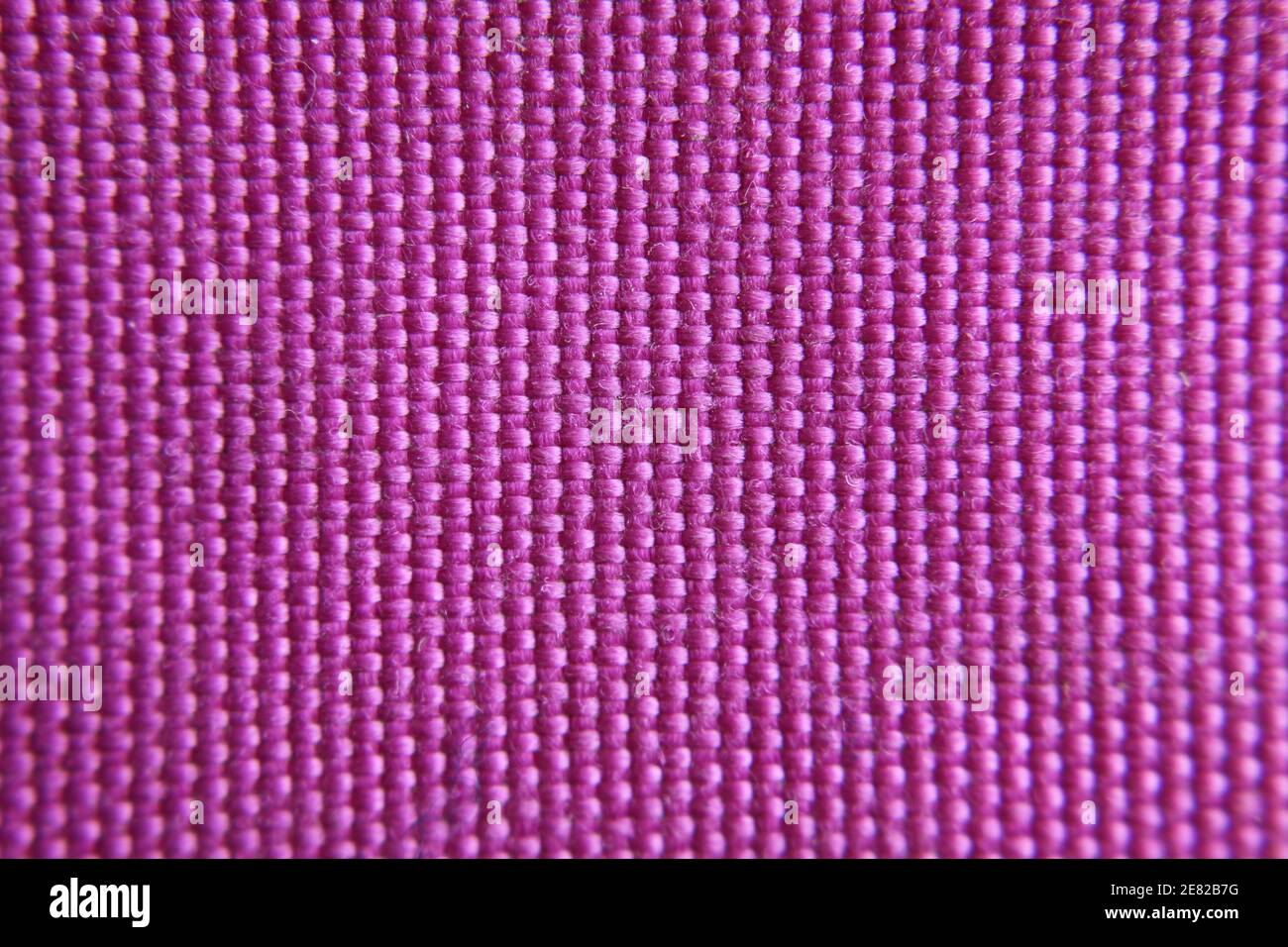 Structure in acrylic wool fabric, pink color, Horizontal macro detail close-up Stock Photo