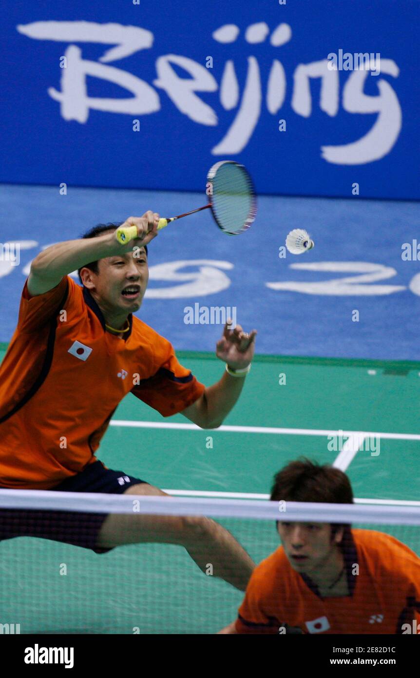 Keita Masuda of Japan (L) hits a shot next to his teammate Tadashi Ohtsuka during their men's doubles round of 16 badminton match against Luluk Hadiyanto and Alvent Yulianto Chandra of Indonesia at the Beijing 2008 Olympic Games, August 12, 2008.     REUTERS/Beawiharta (CHINA) Stock Photo