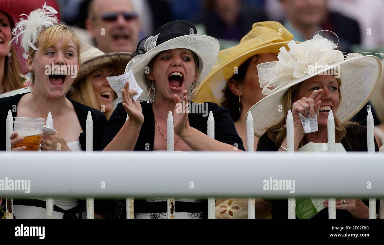 Women react during the third race of the Epsom Derby Festival at Epsom Downs in Surrey, southern England June 6, 2008.    REUTERS/Darren Staples   (BRITAIN) Stock Photo
