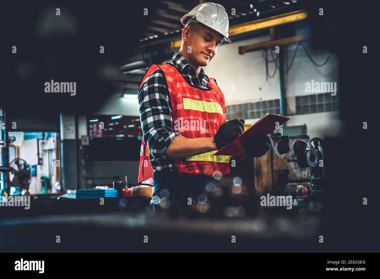 Manufacturing worker working with clipboard to do job procedure
