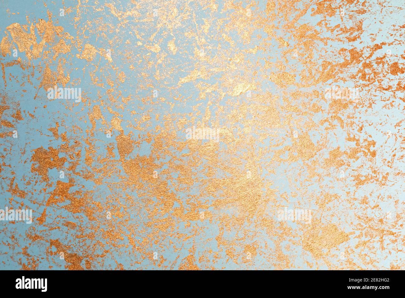 Texture of gold paint on blue paper Stock Photo