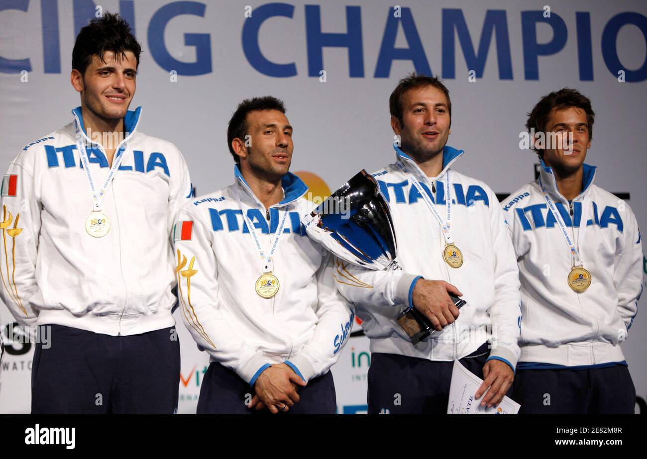 The foil fencing team of Italy (L-R) Andrea Cassara, Stefano Barrera,  Simone Vanni and Andrea Baldini pose with the trophy during the award  ceremony for the men's team foil final fencing event