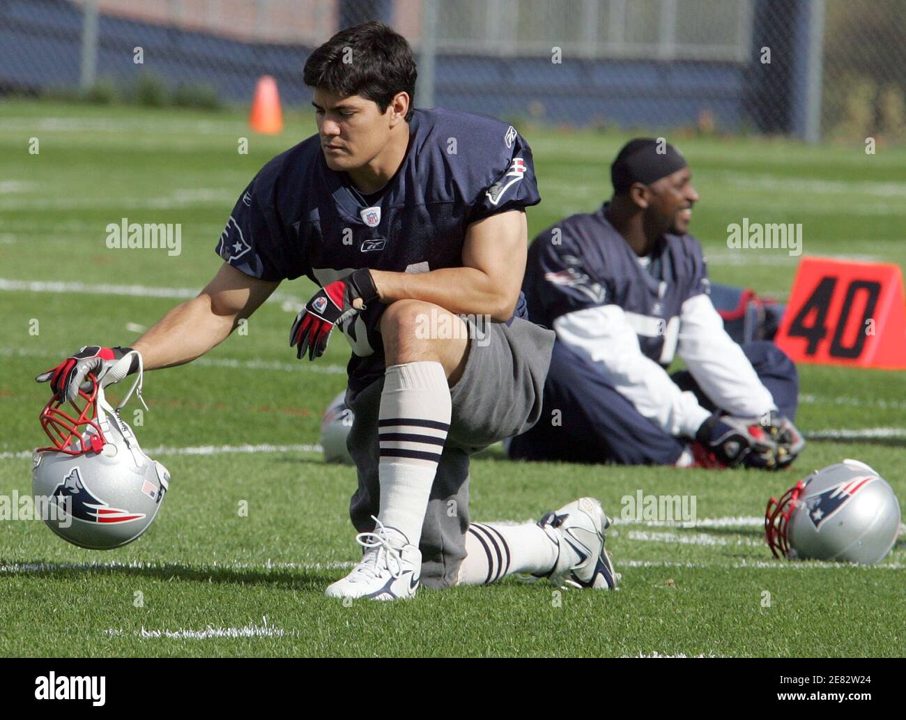 New England Patriots linebacker Teddy Bruschi (R) smiles while talking to  teammates Ty Warren (C) and Larry Izzo in his first practice with the team  in Foxboro, Massachusetts October 19, 2005. This