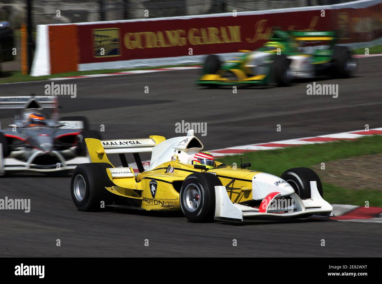 Malaysian Alex Yoong (front) drives his car during the feature race of the A1 Grand Prix Championship at the Sentul circuit in Bogor, West Java province, Indonesia February 12, 2006. Canada's Sean McIntosh won the feature race ahead of Yoong in second place and Australia's Marcus Marshall in third. REUTERS/Beawiharta Stock Photo