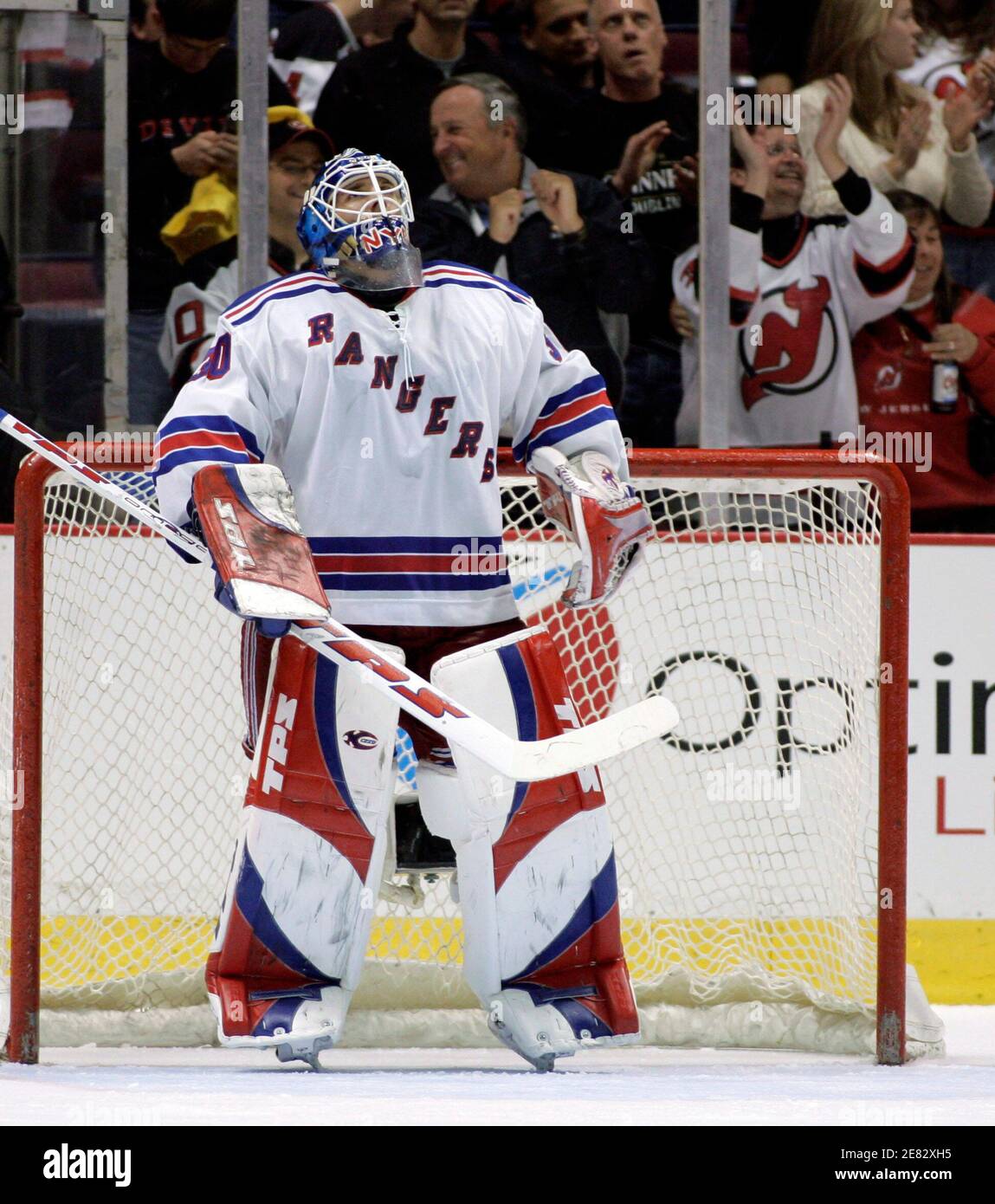 New York Rangers rookie goalie Henrik Lundqvist looks up at the scorebard  as fans celebrate after New Jersey Devils Jamie Langenbrunner scored the  Devils fifth goal in the third period of Game
