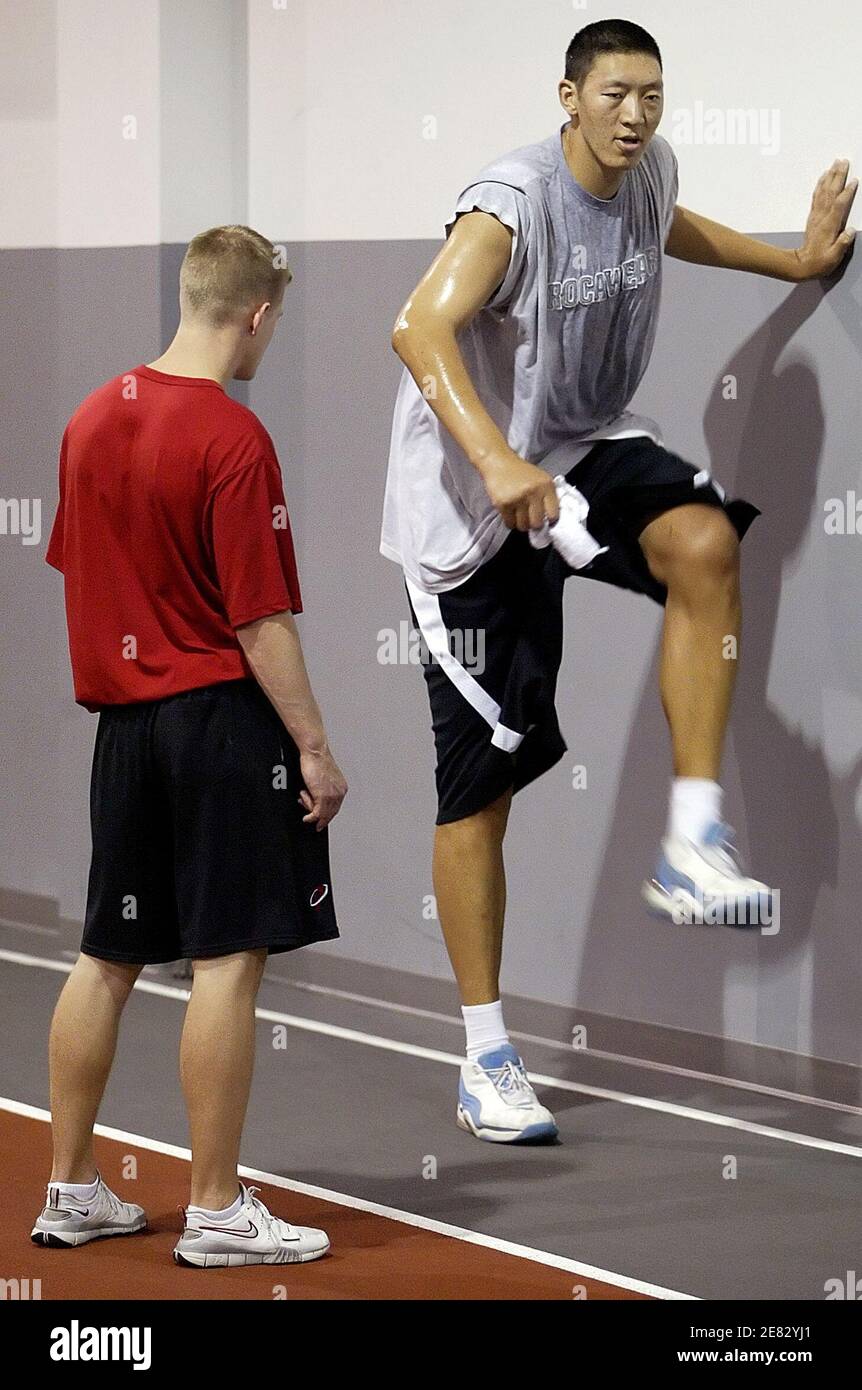 Sun Ming Ming of China, who plays for the United States Basketball League's  (USBL) Dodge City Legend, works out with trainer Chris Shreveport during an  agility training in Greensboro, North Carolina October