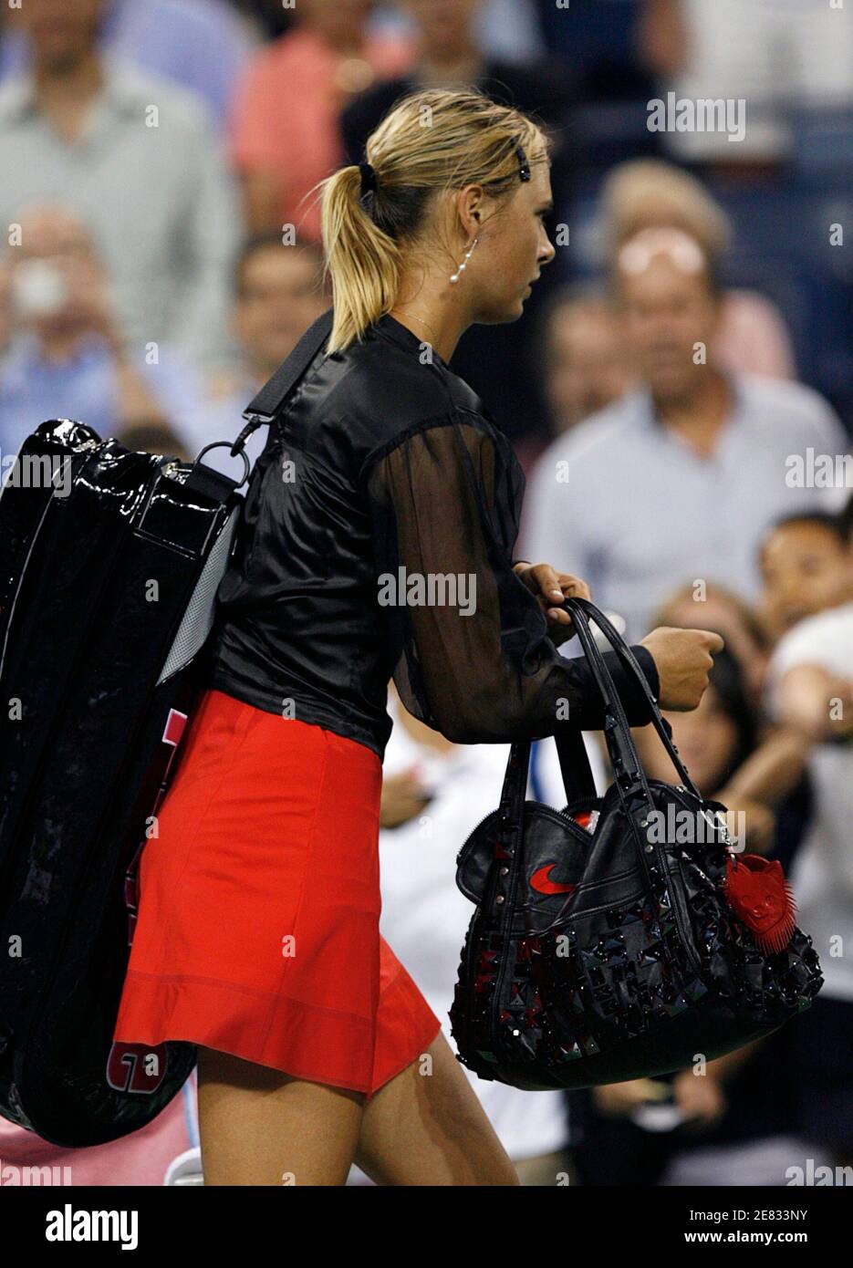 Maria Sharapova of Russia leaves the court with her hand bag and tennis bag  after defeating Roberta Vinci of Italy at the U.S. Open tennis tournament  in Flushing Meadows, New York, August