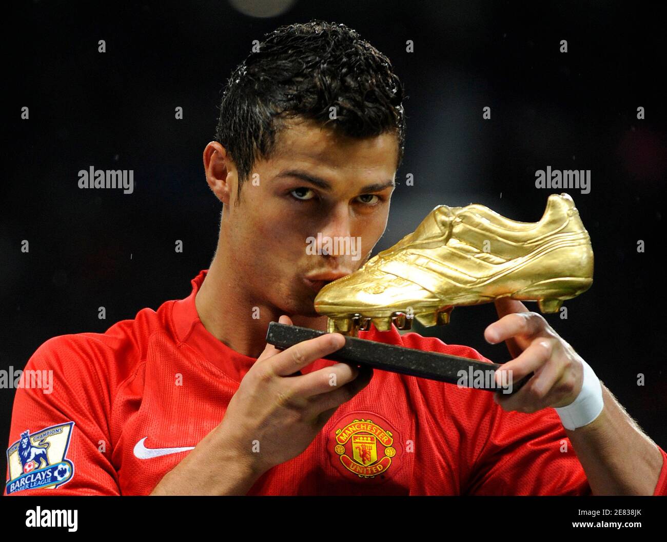 Manchester United's Cristiano Ronaldo kisses the golden boot trophy awarded  to him as 'FIFPro Player of the Year 2008' in a presentation ahead of their  English Premier League soccer match against West