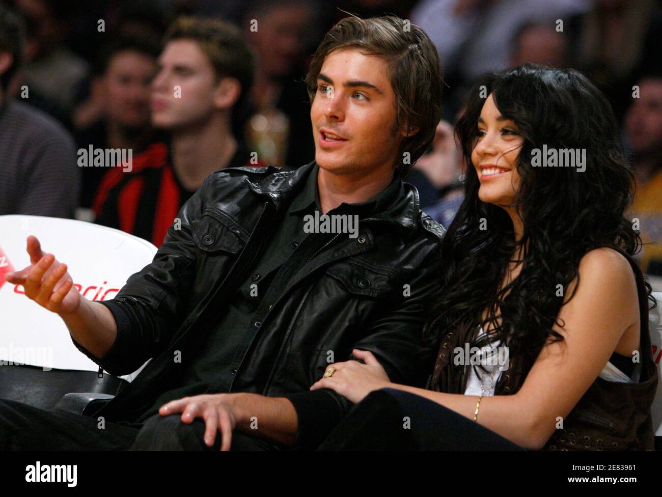 Actors Zac Efron (L) and Vanessa Hudgens watch the New York Knicks play the  Los Angeles Lakers during their NBA basketball game in Los Angeles,  December 16, 2008. REUTERS/Lucy Nicholson (UNITED STATES