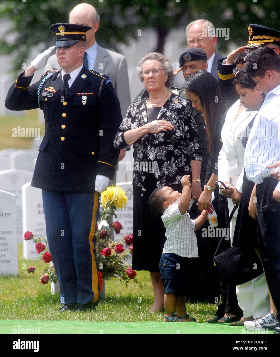 Eighteen-month-old Greg Sutton reaches for his mother, Joane Sutton the wife of Army Sgt. 1st Class Greg Lamonte Sutton, 38, who died on June 6 after his vehicle struck an improvised explosive device in Baghdad, is hold in Arlington Cemetery June 20 2007 in Virginia. Since the begining of the war, 378 soldiers have been buried in Arlington Cemetery.(Pictured: Greg Sutton, Joane Sutton) Photo by Olivier Douliery/ABACAPRESS.COM Stock Photo