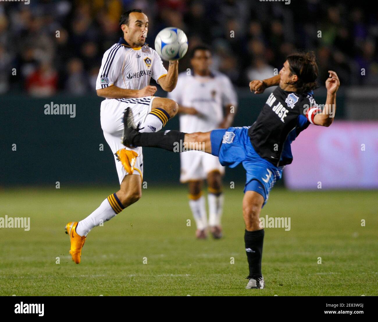 Los Angeles Galaxy's Landon Donovan (L) fights for the ball with San Jose Earthquakes' Nick Garcia during the opening season game of their Major League Soccer game in Carson, California  April 3, 2008.    REUTERS/Mike Blake      (UNITED STATES) Stock Photo