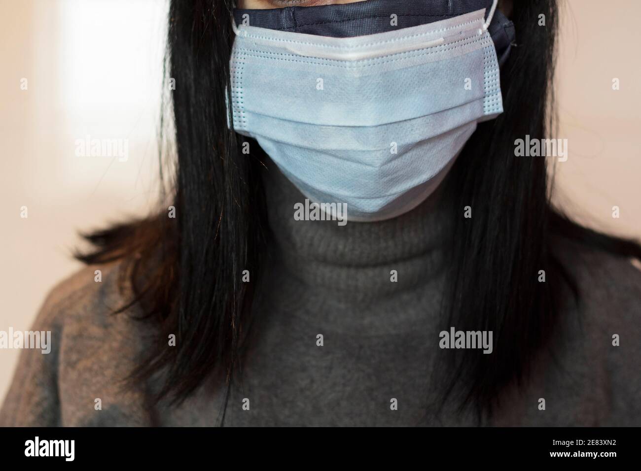 Woman using two face masks Stock Photo Alamy