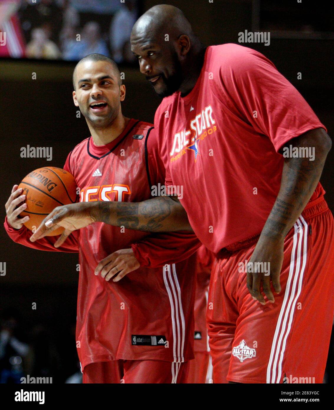 Shaquille O'Neal from the Phoenix Suns (R) jokes with Tony Parker of France  from the San Antonio Spurs during team practice for the NBA All-Star  basketball game in Phoenix, Arizona, February 14,