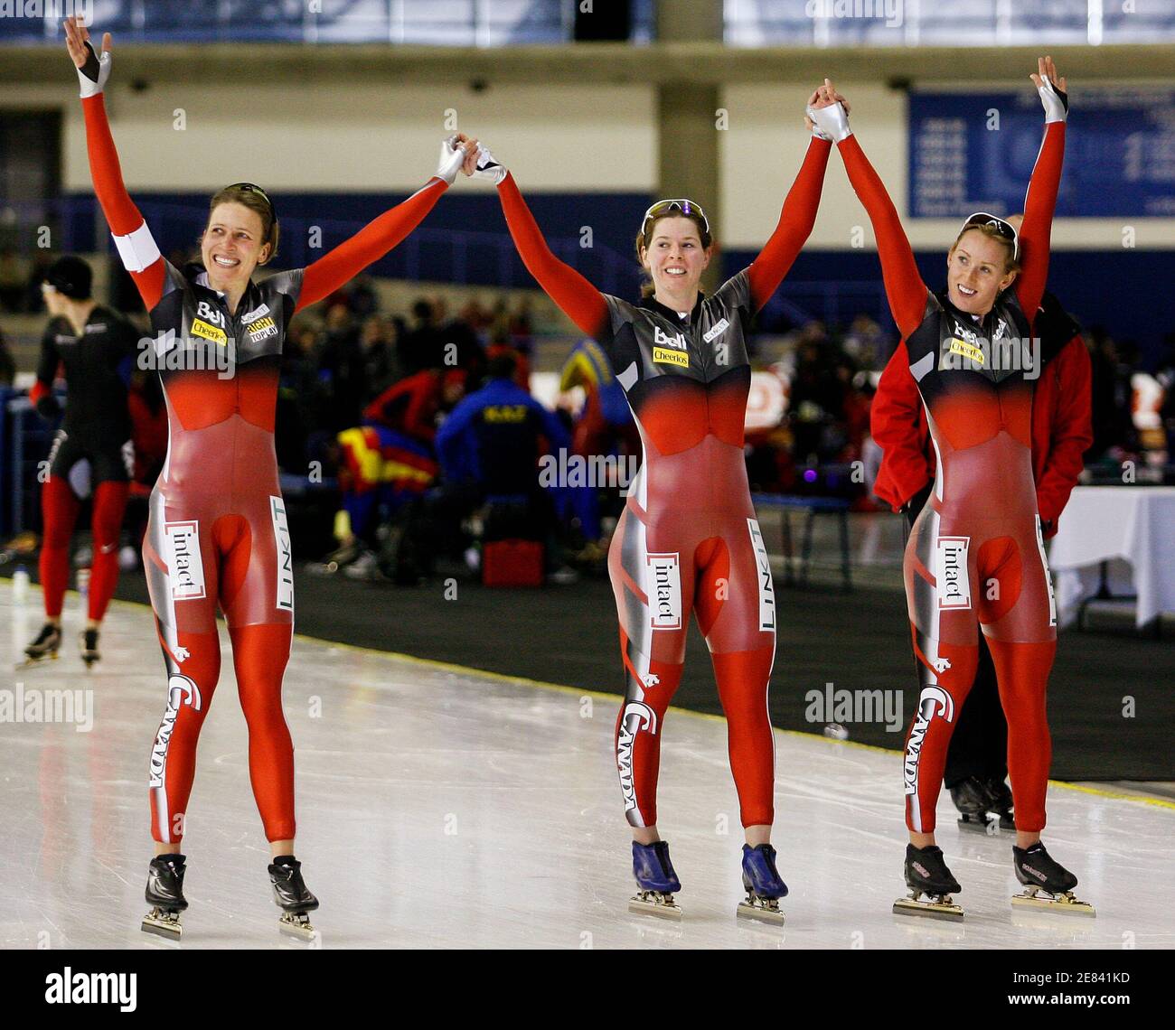 Kristina Groves (L), Christine Nesbitt (C) and Brittany Schussler of Canada celebrate their new world record in the ladies team pursuit event during the ISU World Cup speed skating race in Calgary, Alberta, December 6, 2009. REUTERS/Todd Korol  (CANADA SPORT SPEED SKATING) Stock Photo