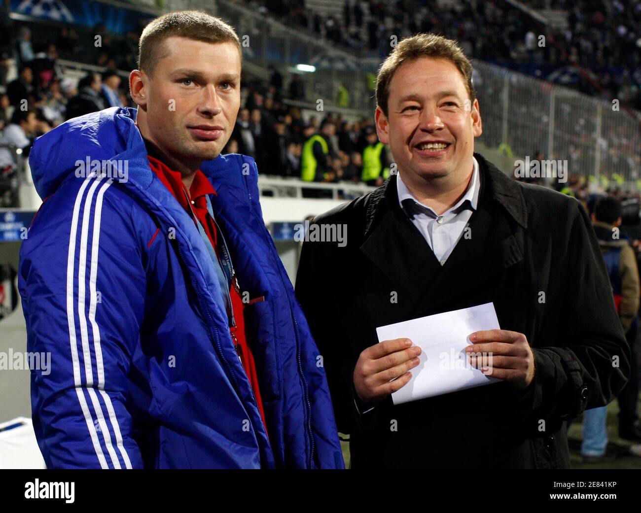 CSKA Moscow's coach Leonid Slutsky (R) chats with his defender Alexei  Berezutsky before their Champions League soccer match aginst Besiktas at  Inonu stadium in Istanbul December 8, 2009. CSKA Moscow defenders Sergei