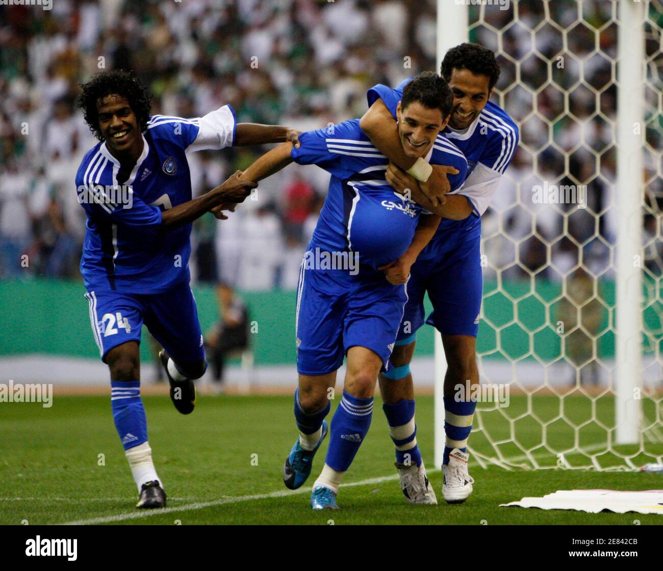 Al-Hilal players Yasser Al Qahtani (R), Abed Al Raheem Al Jezawi (L) and Tako Nafeez celebrate after scoring against Al-Ahli during their Saudi Crown Prince Cup final soccer match in Riyadh February 19, 2010. REUTERS/Fahad Shadeed (SAUDI ARABIA - Tags: SPORT SOCCER) Stock Photo