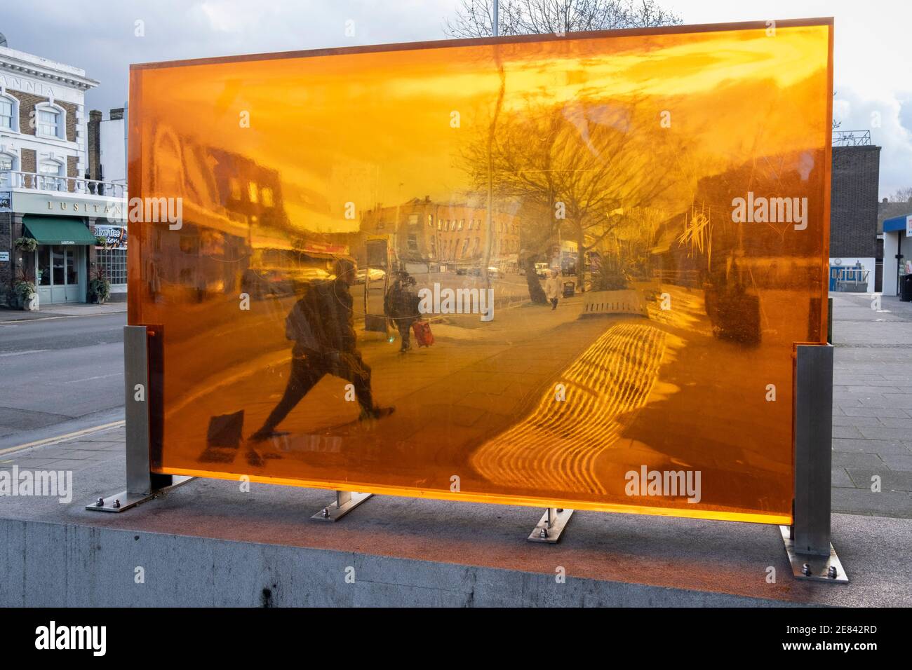 Seen through an orange-coloured prism, a figure walks along a south ...