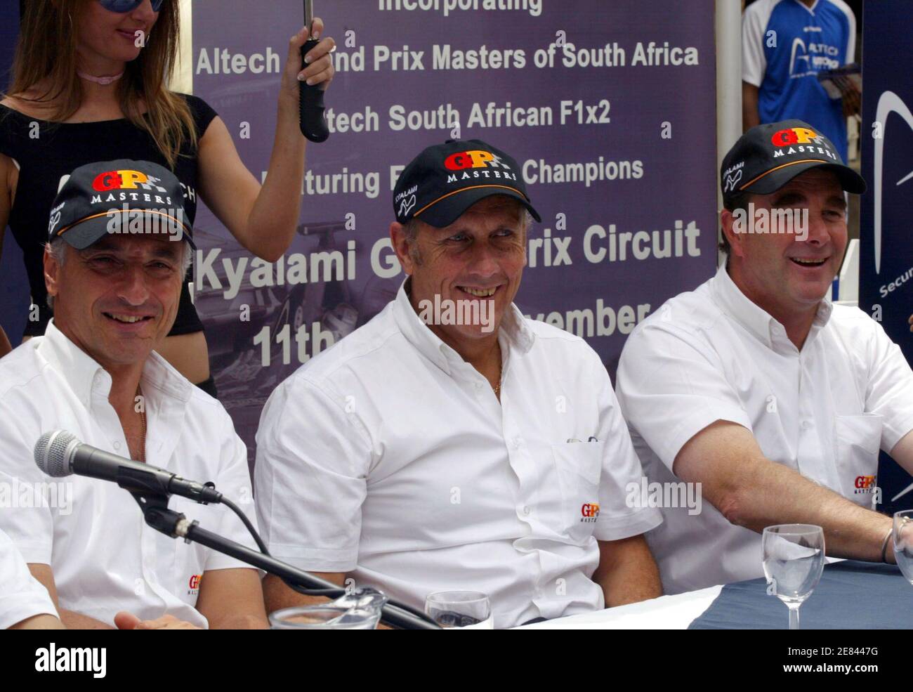 Britain's Nigel Mansell (R), Hans Stuck (C) from Germany and Riccardo Patrese (L) from Italy smile during a news conference at Sandton City square November 10,2005. South African Grand Prix Master series, take part in a first ever public demonstration of power around the streets of Sandton Central. REUTERS/Juda Ngwenya Stock Photo