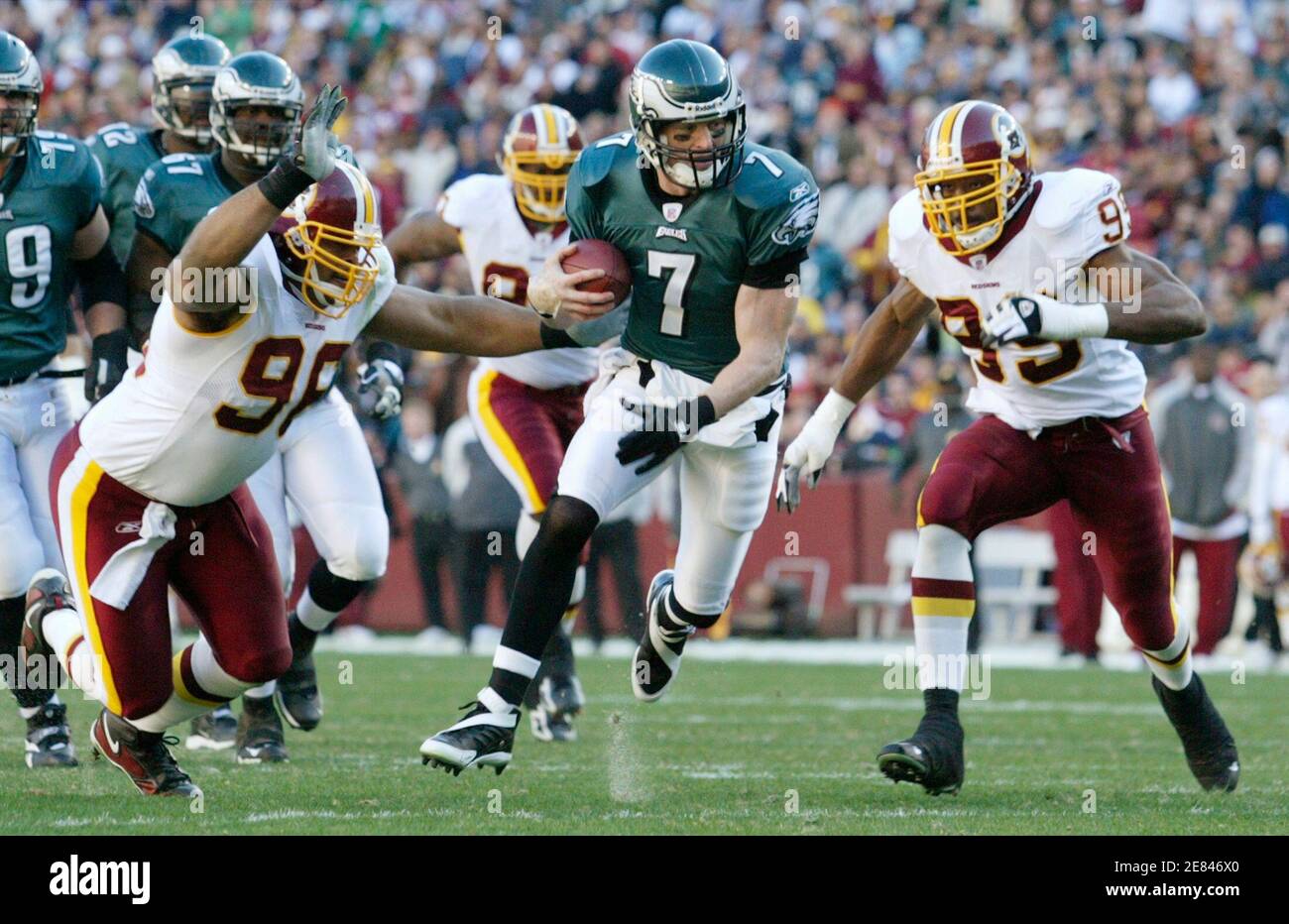 Philadelphia Eagles quarterback Jeff Garcia (C) scrambles for yardage in the first half while being pursued by Washington Redskins defenders Lemar Marshall (L) and Andre Carter (R) during their NFL football game in Landover, Maryland December 10, 2006.      REUTERS/Gary Cameron  (UNITED STATES) Stock Photo
