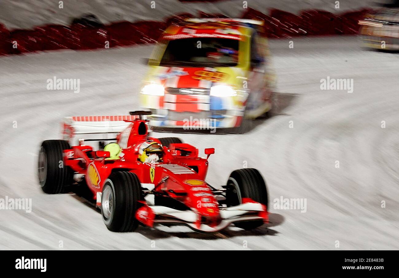 Ferrari F1 Test Driver Luca Badoer Of Italy Leads His Ferrari Formula One Car His Team Mate Test Driver Mark Gene Of Spain During An Exhibition On An Ice Rink With 4x4