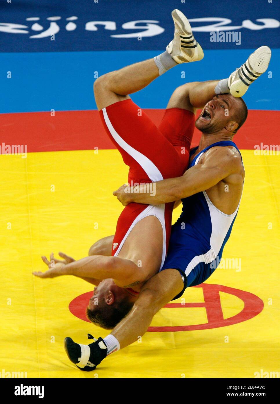 Aslanbek Khushtov of Russia (in blue) fights Mirko Englich of Germany at the men's 96kg Greco-Roman gold medal wrestling competition at the Beijing 2008 Olympic Games August 14, 2008.     REUTERS/Oleg Popov (CHINA) Stock Photo