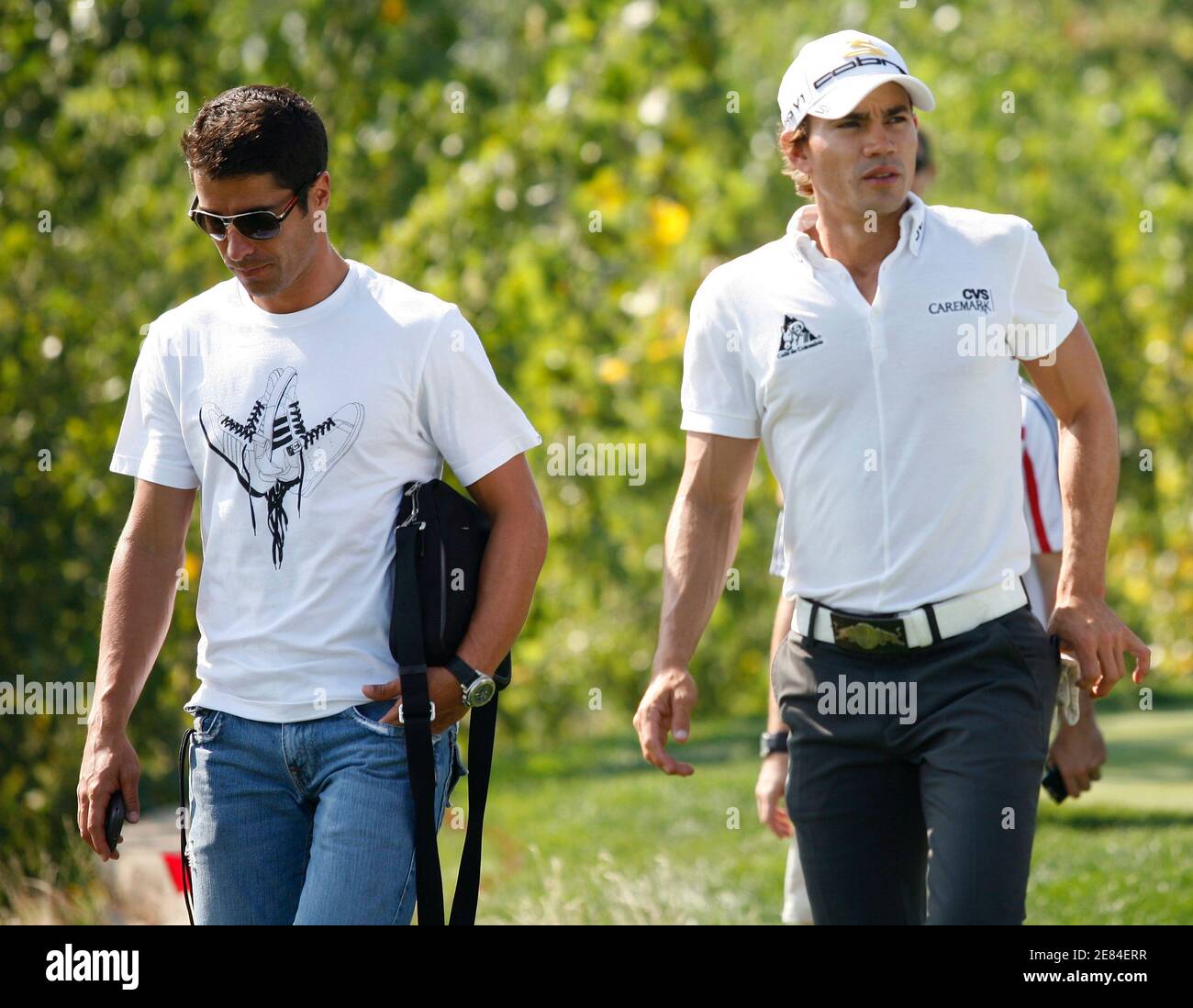 Golfer Camilo Villegas (R) of Colombia walks with New York Red Bulls soccer  player Juan Pablo Angel (L) of Colombia along the 18th fairway during a  practice round for The Barclays golf