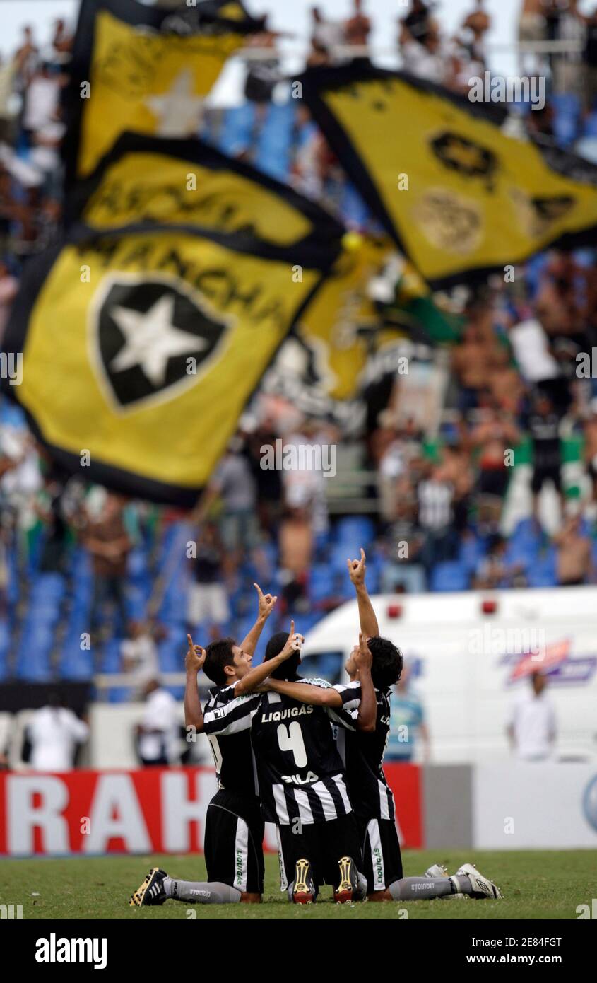 Botafogo's Lucio Flavio (L), Wellington (C) and Fahel celebrates after their team mate Jobson (not inpicture) scores against Palmeiras during their Brazilian Championship soccer match at Joao Havelange stadium in Rio de Janeiro December 6, 2009. REUTERS/Ricardo Moraes (BRAZIL SPORT SOCCER IMAGES OF THE DAY) Stock Photo