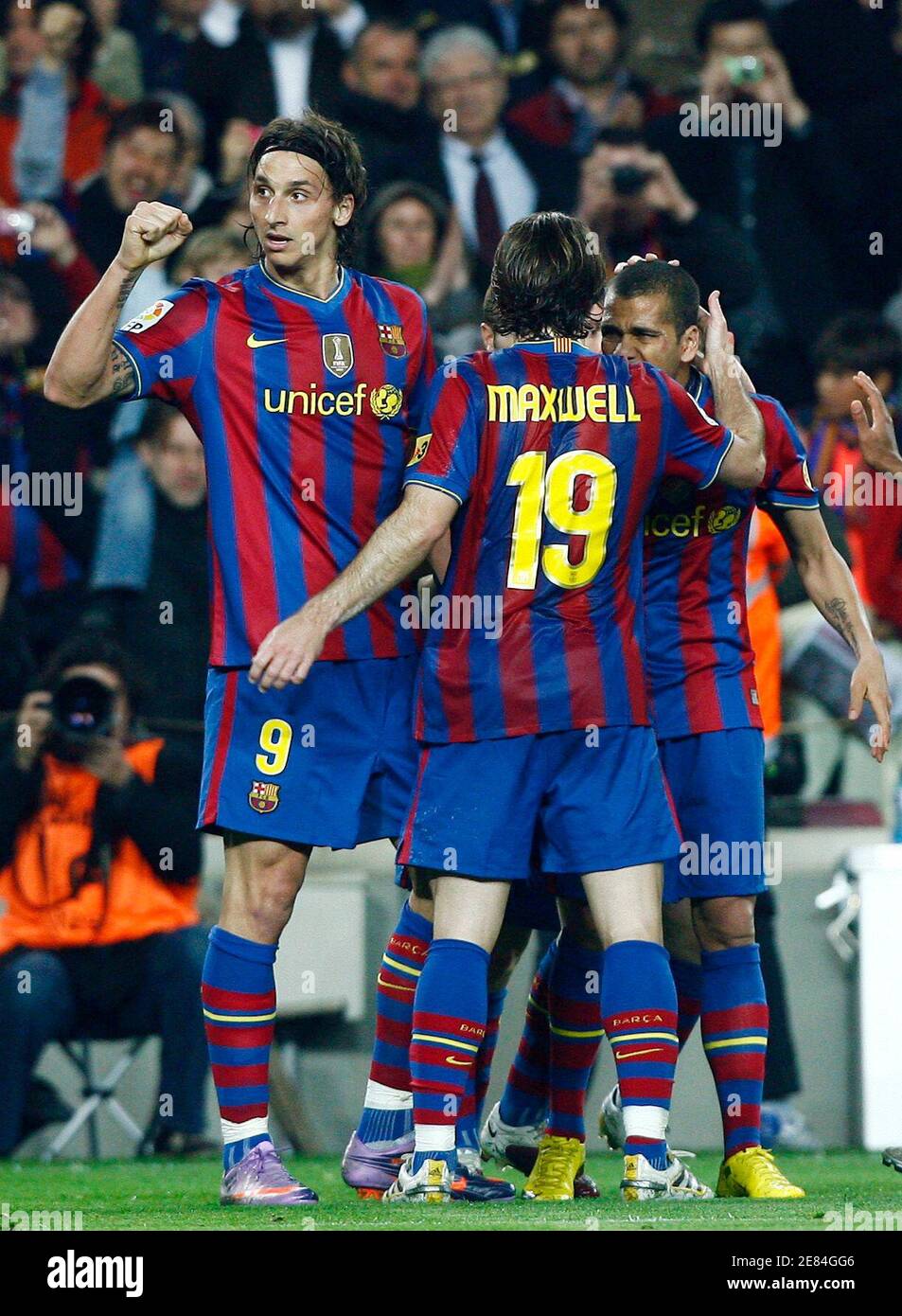 Barcelona's Zlatan Ibrahimovic, Maxwell (C) and Daniel Alves (R) celebrate  a goal against Osasuna during their Spanish first division soccer match at  Camp Nou stadium in Barcelona, March 24, 2010. REUTERS/Albert Gea (
