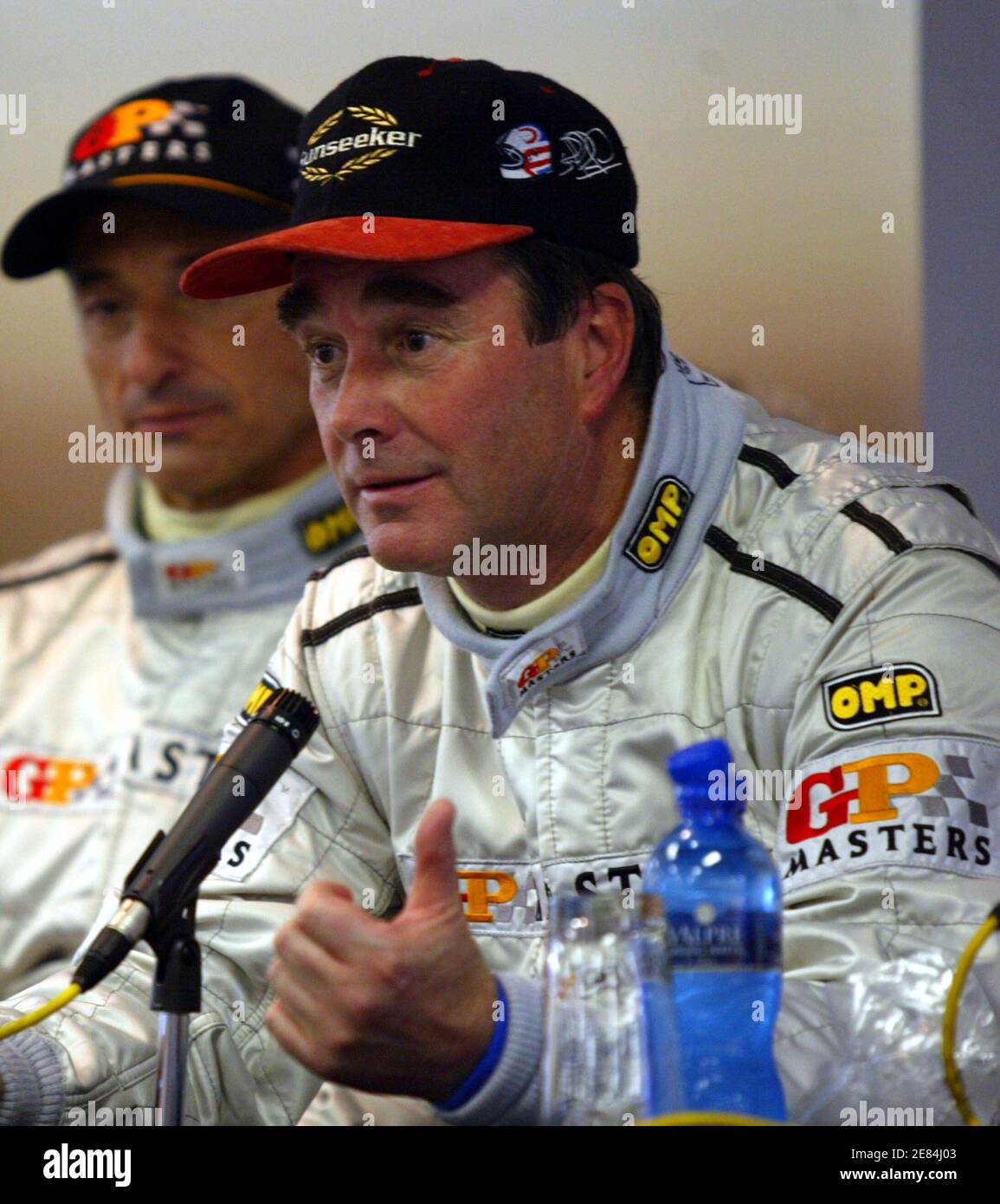 Britain's Nigel Mansell (R) speaks at the news conference at Kyalami circuit, near Johannesburg November 12, 2005. Mansell claimed pole position for the inaugural Grand Prix Masters race at the Kyalami circuit in Johannesburg on Saturday. REUTERS/Juda Ngwenya Stock Photo