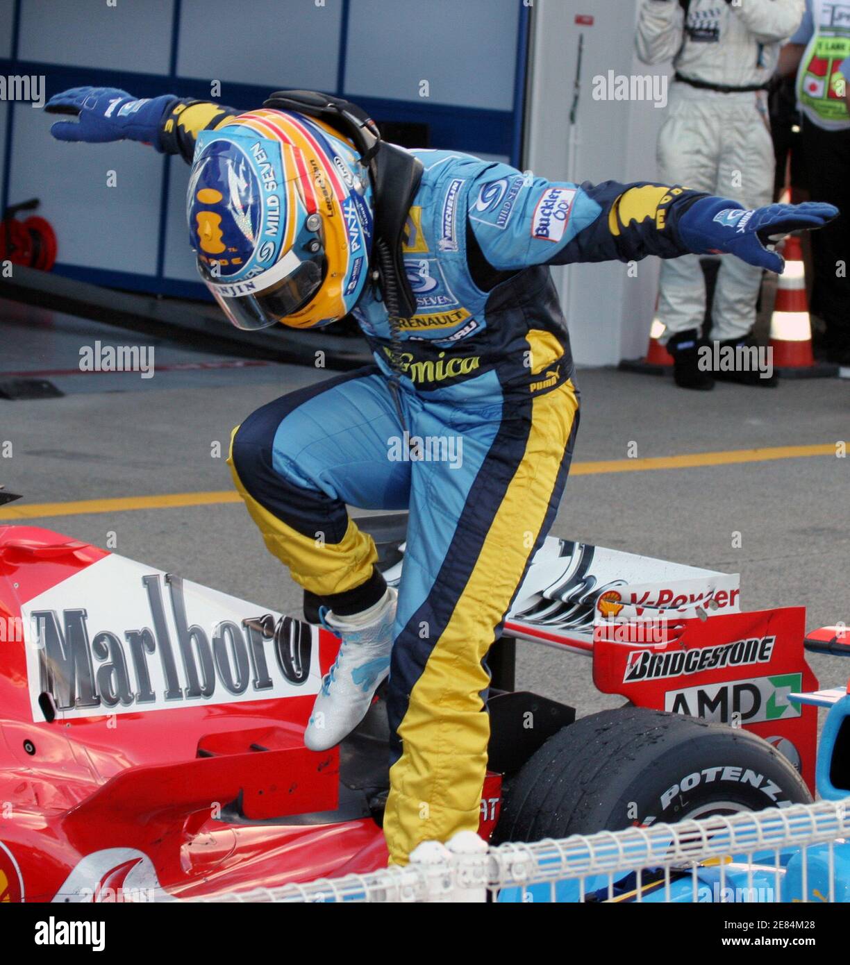 Renault Formula One driver Fernando Alonso of Spain dances in celebration after winning the