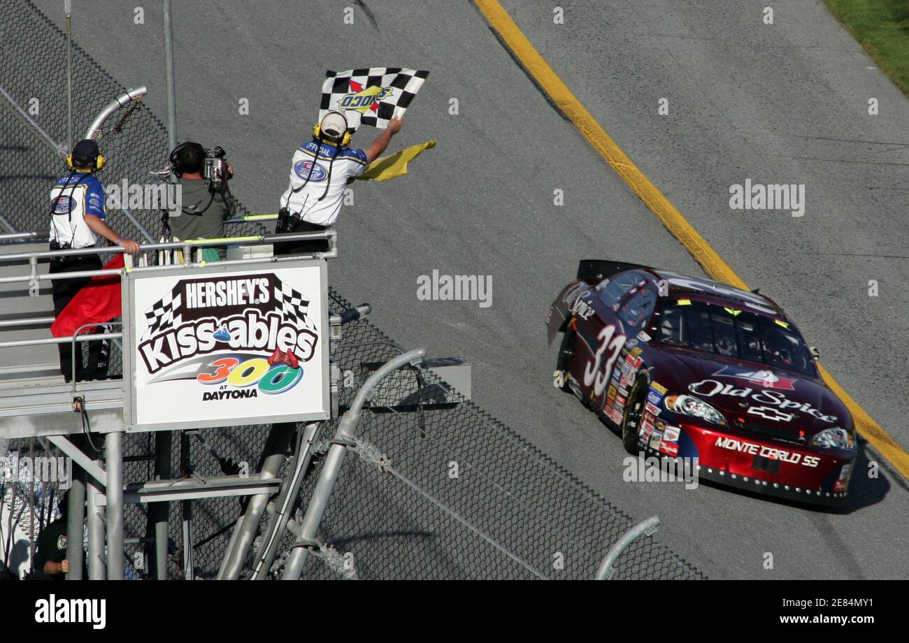 Tony Stewart takes the checkered flag in his number 33 Old Spice Chevrolet to win The Hershey's Kissables 300 Busch Series race at the Daytona International Speedway in Daytona Beach, Florida February 18, 2006. The event leads up to running of the 48th Daytona 500 NASCAR race on February 19. REUTERS/Rick Fowler Stock Photo
