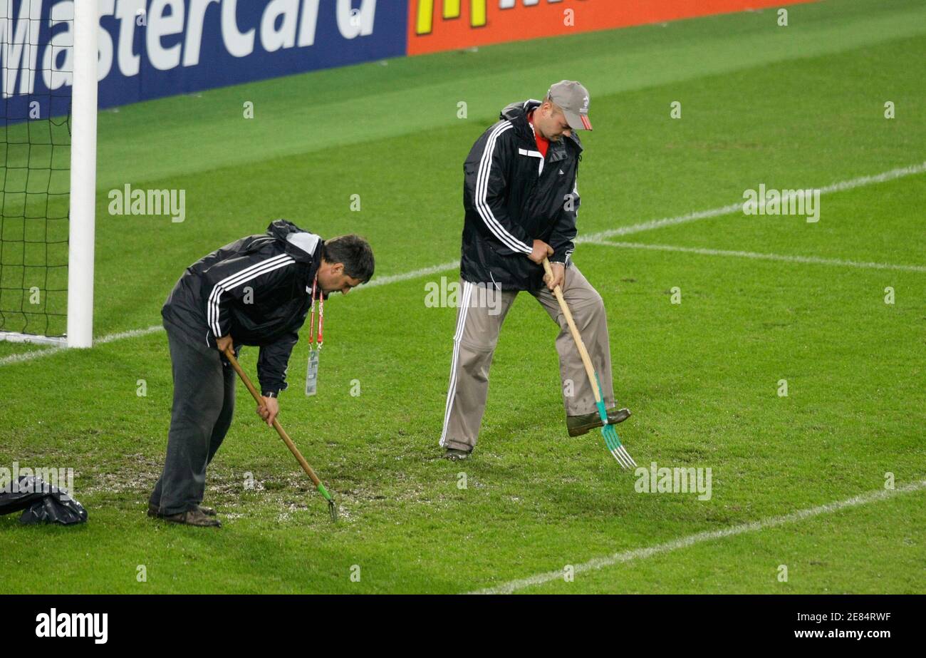 Workers tend to the rain soaked pitch during halftime of the Group A Euro  2008 soccer match between Turkey and Switzerland at St Jakob Park in Basel,  June 11, 2008. REUTERS/Pascal Lauener (