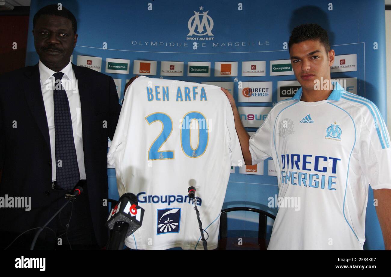 France's soccer player Hatem Ben Arfa (R) presents his new jersey with  Olympique Marseille's President Pape Diouf during a news conference in  Marseille July 2, 2008. The French Professional Soccer League (LFP)