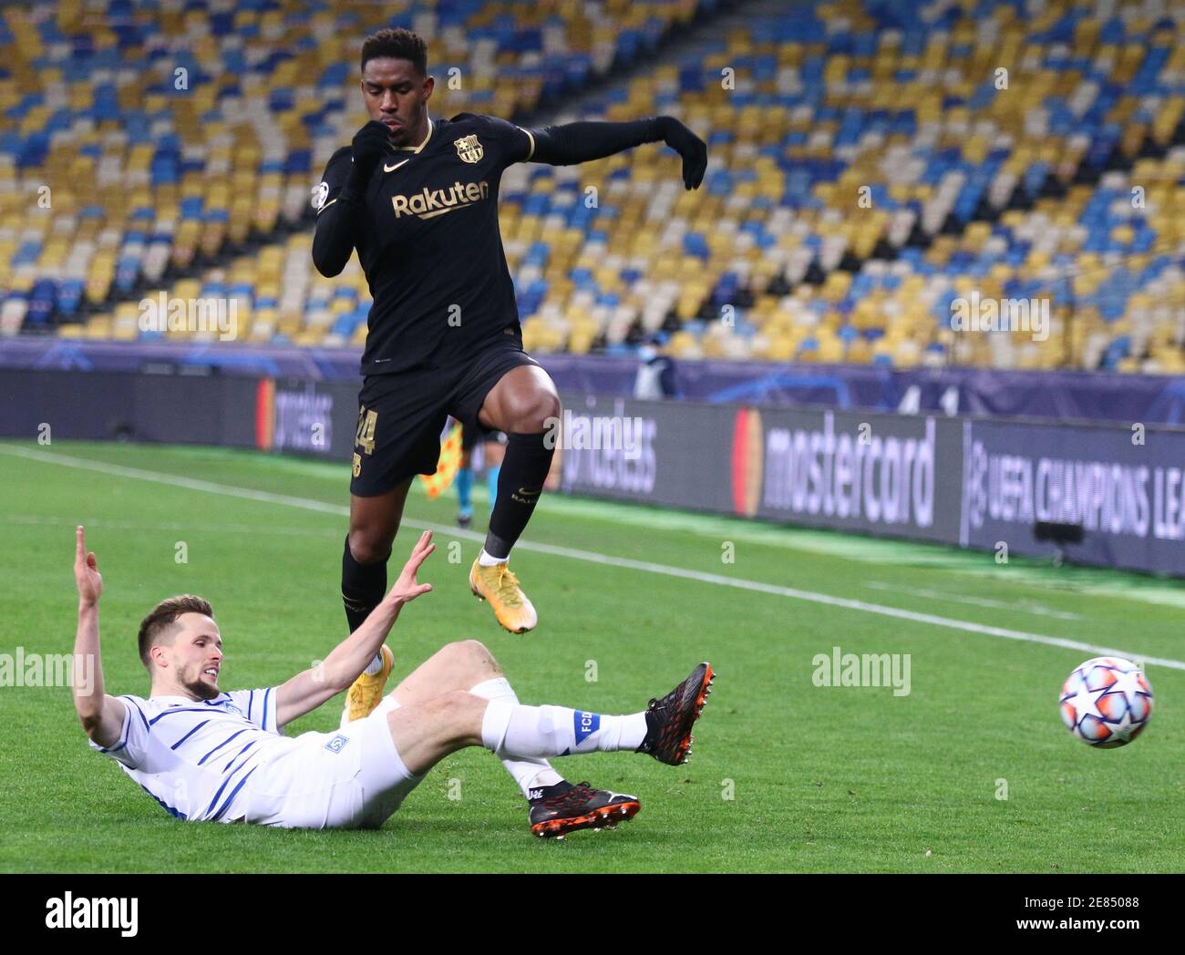 KYIV, UKRAINE - NOVEMBER 24, 2020: Tomasz Kedziora of Dynamo Kyiv (L) fights for a ball with Junior Firpo of Barcelona during their UEFA Champions League game at NSC Olimpiyskyi stadium in Kyiv Stock Photo