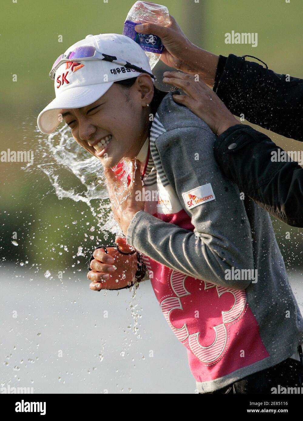 Choi Na-yeon of South Korea is congratulated by compatriot Kim Song-hee on  the 18th green after Choi's victory at the LPGA Hana Bank-Kolon Championship  golf tournament at Sky72 Golf Club Ocean course
