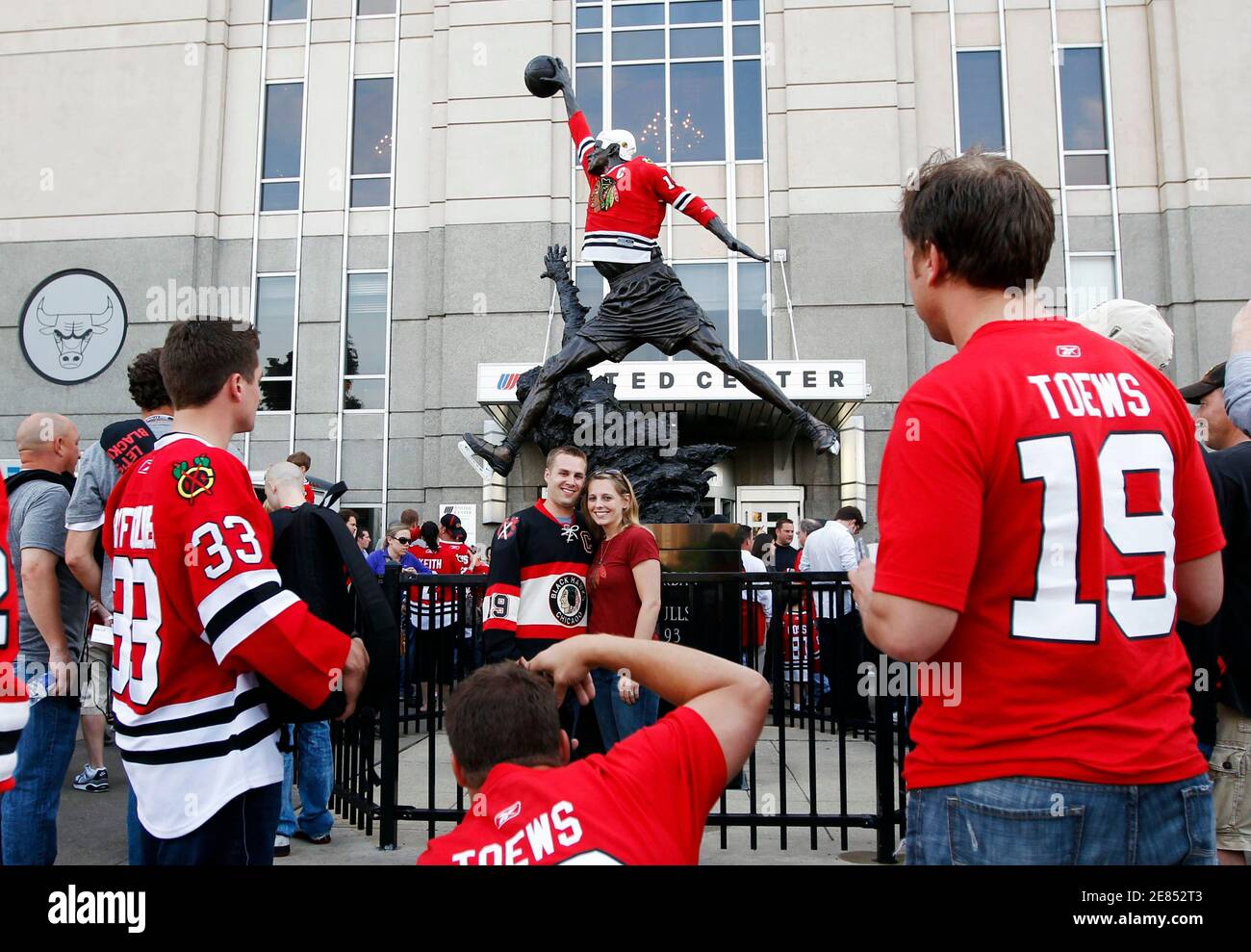 Fans pose in front of a Michael Jordan statue with a Chicago Blackhawks  jersey on it before the Philadelphia Flyers play the Chicago Blackhawks in  Game 2 of the NHL Stanley Cup