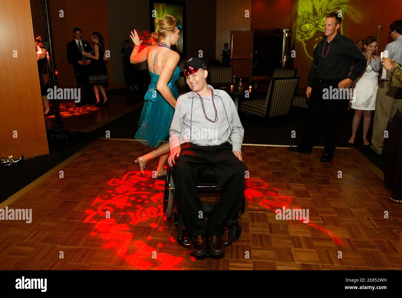 Mike Bamford, 17, participates in a dance while seated in his wheelchair with sister Natalie at a prom organised by The Children's Hospital for cancer patients, in Denver June 8, 2010. Mike has been fighting leukaemia since September 2009 and was recently discharged from the hospital. Picture taken June 8, 2010.    REUTERS/Rick Wilking (UNITED STATES - Tags: HEALTH SOCIETY) Stock Photo