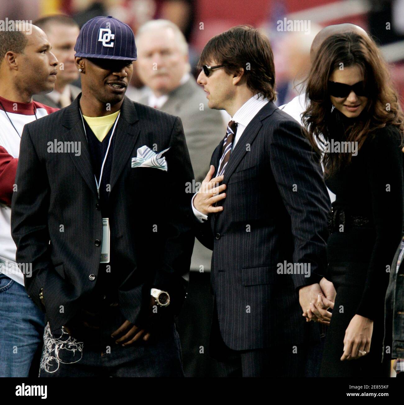 Actors Jamie Foxx (L), Tom Cruise (C) and Katie Holmes talk on the Washington Redskins sidelines before the Monday Night Football game against the Minnesota Vikings in Landover, Maryland September 11, 2006.     REUTERS/Gary Cameron  (UNITED STATES) Stock Photo