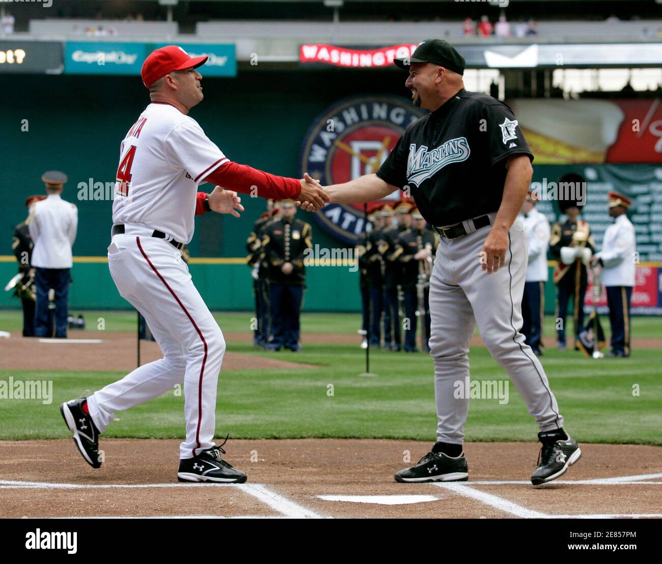 New major league managers Manny Acta (L) of the Washington Nationals and Florida Marlins manager Fredi Gonzalez shake hands prior to their MLB baseball's Opening Day in Washington April 2, 2007. Gonzalez's team came away with the win.   REUTERS/Gary Cameron  (UNITED STATES) Stock Photo