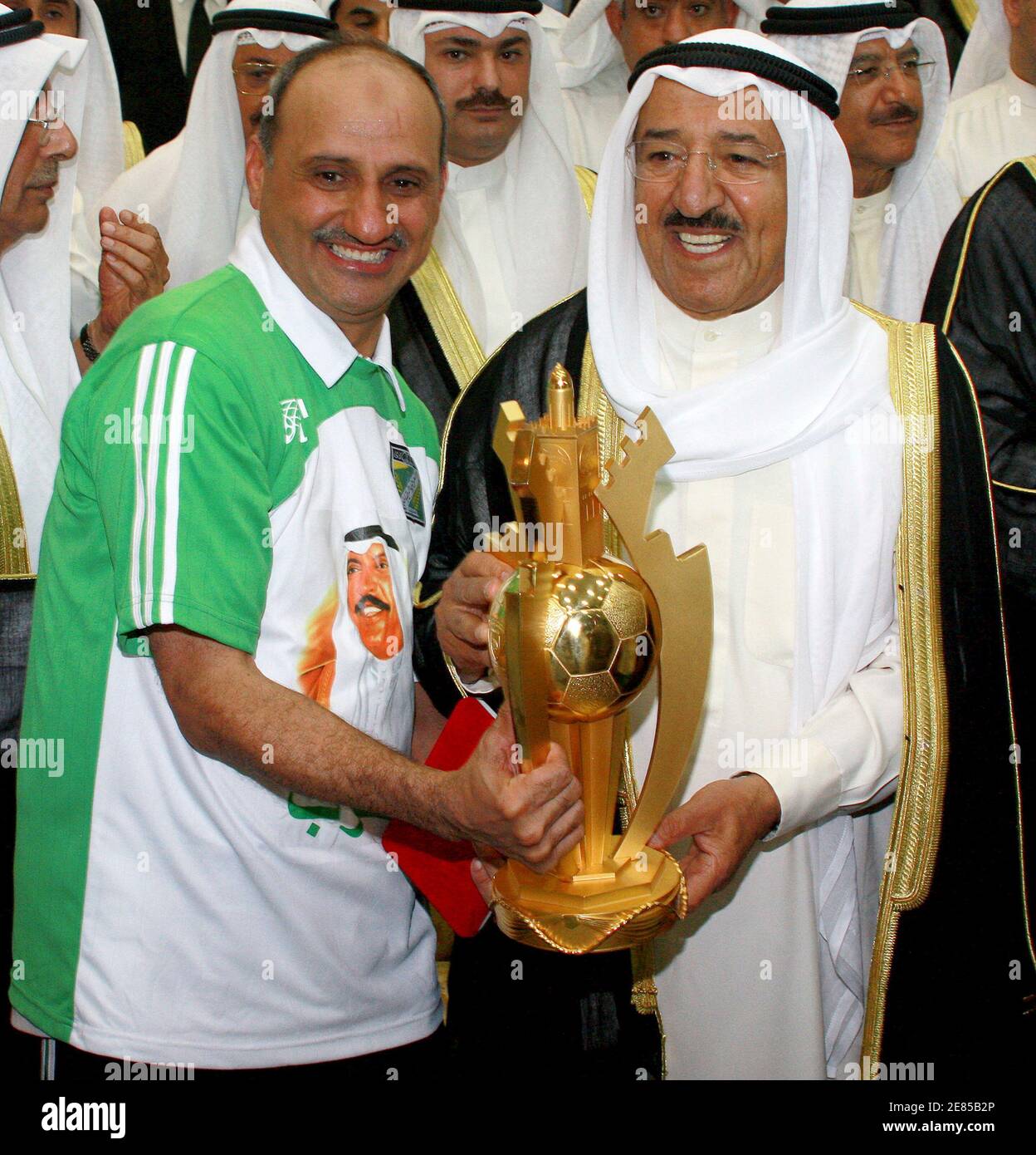 Kuwait's Amir Sheikh Sabah Al-Ahmed Al-Sabah (R) hands the Amir Cup to  Al-Arabi's coach Ahmed Khalaf after the final soccer match against  Al-Salmiya in Kuwait City May 25, 2008. REUTERS/Tariq AlAli (KUWAIT