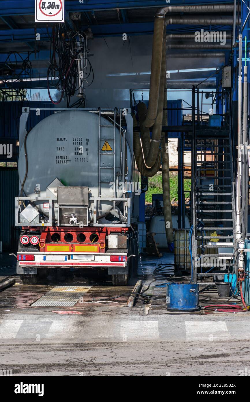 Tank truck inside a specific car wash for this type of vehicle Stock