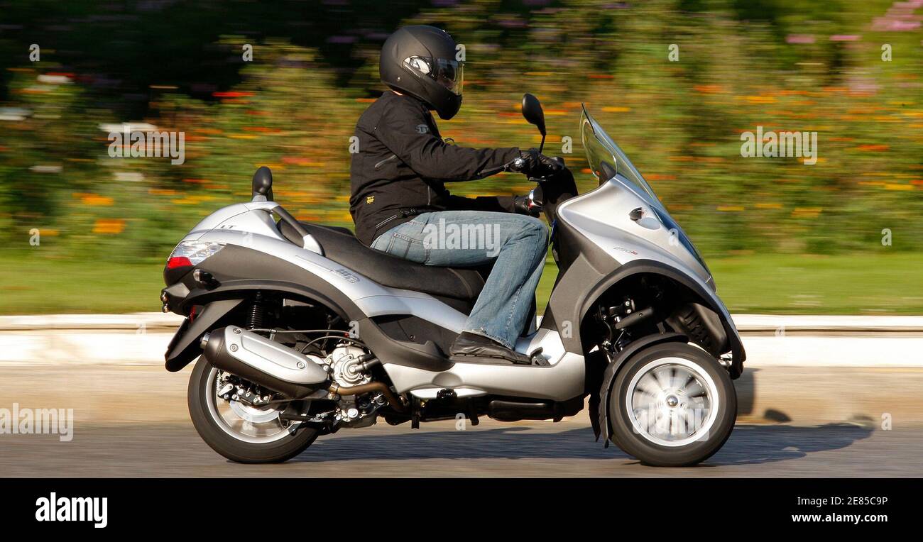 A member of the media rides the new scooter Piaggio MP3 in Paris September  26, 2008. The Piaggio MP3 will be available soon in a special 250cc and 400  cc configuration for