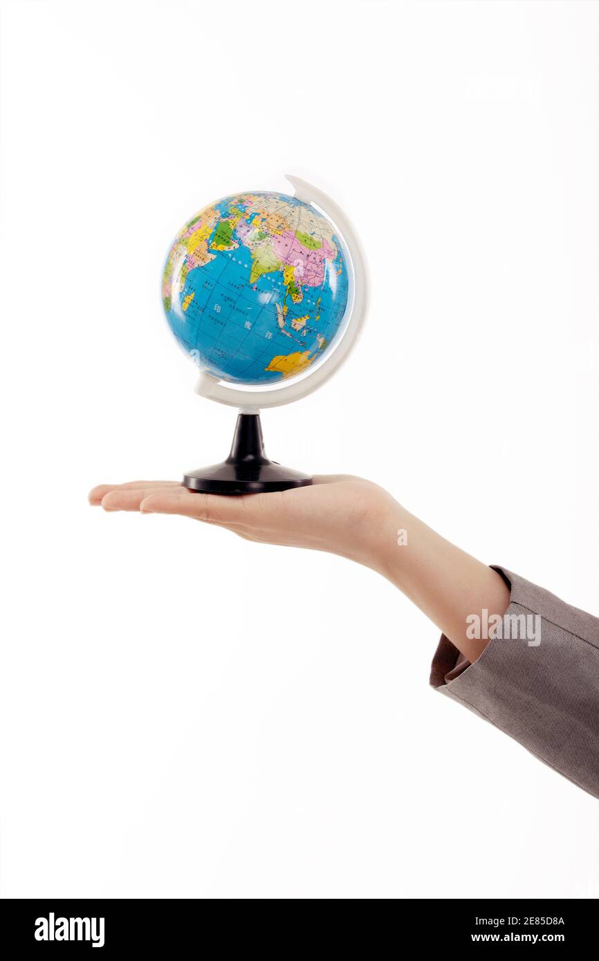 Woman globe in hand hi-res stock photography and images - Alamy